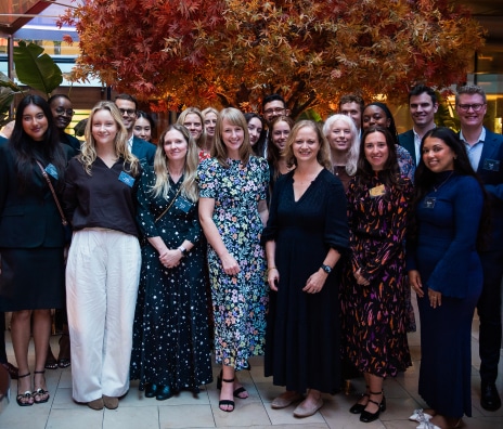 Large group of Vested team members gathered together at an indoor networking or company event