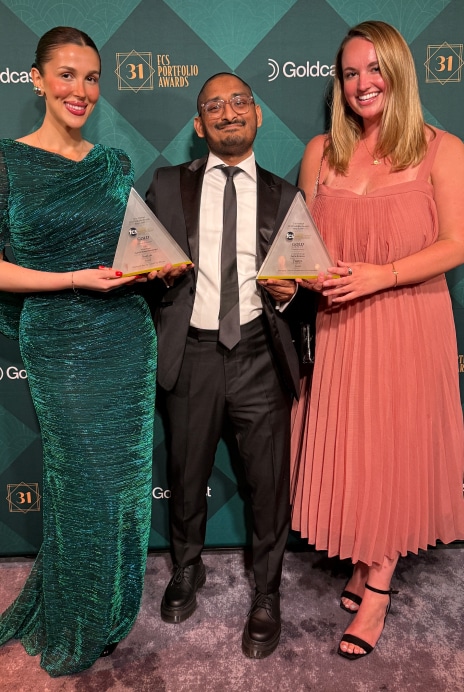 Three team members holding awards at the FCS Portfolio Awards ceremony